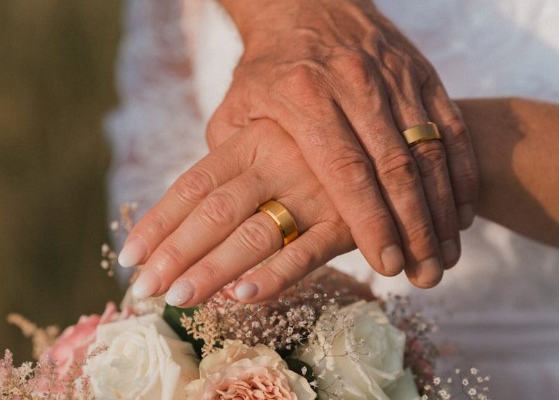 person holding bouquet of pink roses